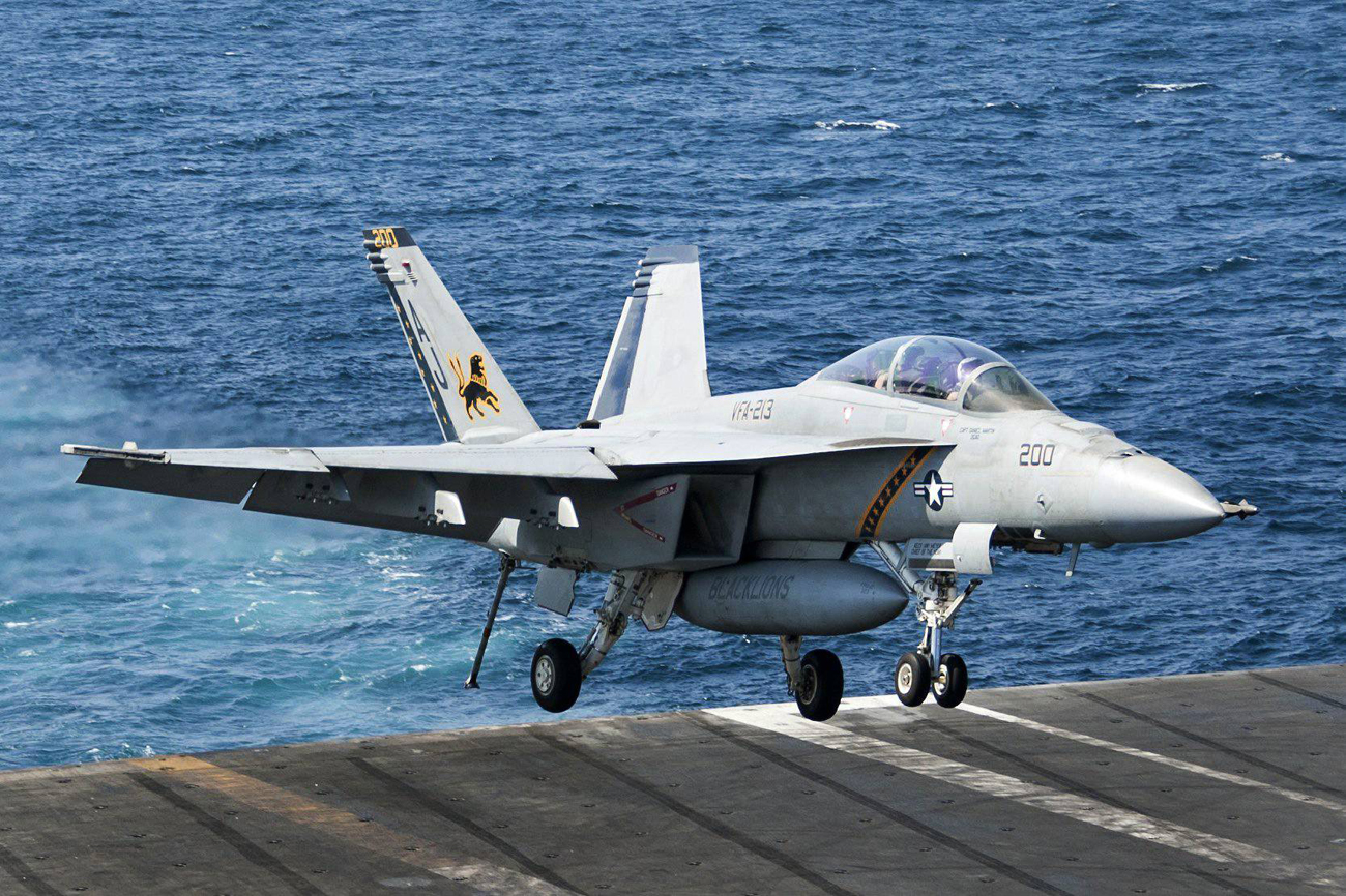 An American F-18 lands back on an aircraft carrier after flying a mission against ISIS. (Photo: MCT) (Photo: MCT)