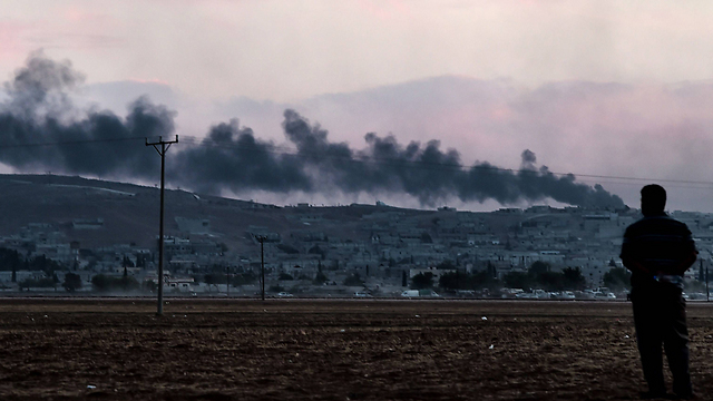 Man watches aftermath of coalition strike (Photo: AFP)
