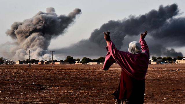 A woman watching US bombarding IS targets in Kobani