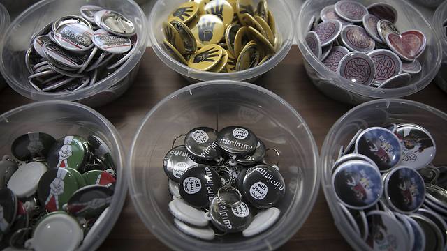 Pins bearing the militants' black-and-white flag (Photo: AP)
