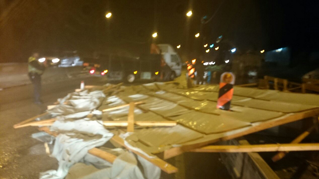 Makeshift roof blown across Route 1 (Photo: Police)