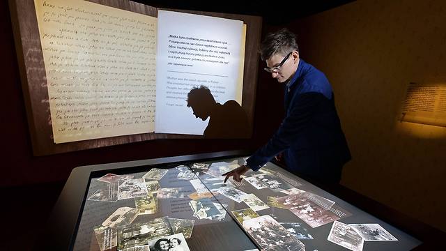 A museum's employee explains artefacts at the Core exhibition in the Museum of the History of Polish Jews (Photo: AFP)