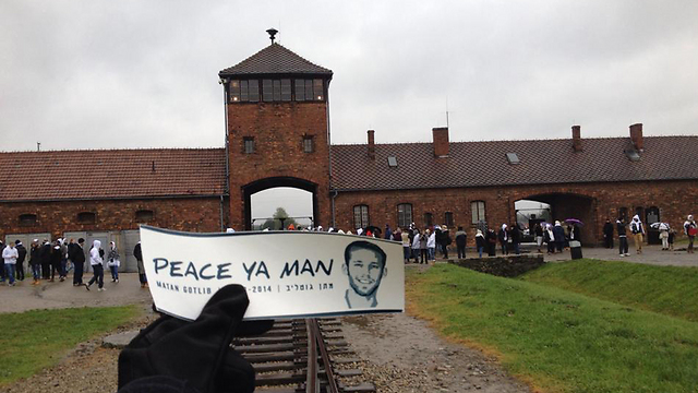A sticker with the phrase "peace ya man" written by fallen soldier Matan Gotlib in front of the Auschwitz concentration camp in Poland.