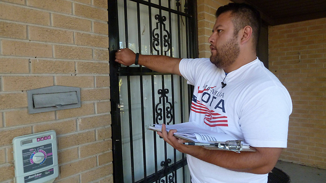 מתנדב עובר בין בתים באורורה, קולורדו, לשכנע היספנים להצביע בבחירות האמצע (צילום: AP) (צילום: AP)