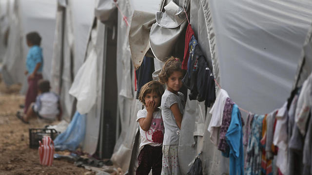 Syrian Kurdish refugee children who fled Kobani stand outside tent at refugee camp in Suruc, Turkey (Photo: AP) (Photo: AP)