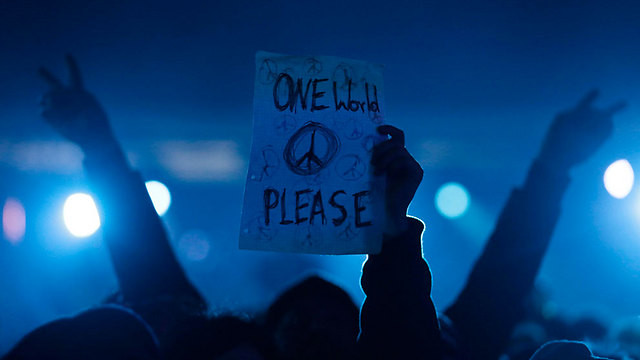 "עולם אחד, בבקשה". שלט שהונף בקהל בברלין (צילום: AP ) (צילום: AP )