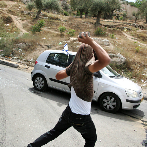A Palestinian throwing stones in Silwan, East Jerusalem. (Photo: EPA)
