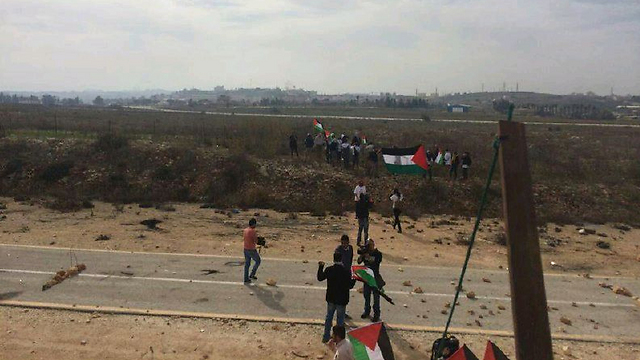 Palestinians crossing the border fence in Qalandiya.