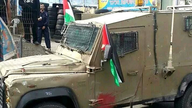 IDF jeep on which Palestinians put flags in Hizma square.