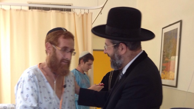 The Chief Rabbi of Israel visits Yehuda Glick at Shaare Zedek Medical center in Jerusalem.