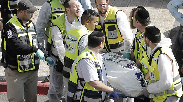 Removing a body from the scene of the attack. (Photo: AFP) (Photo: AFP)