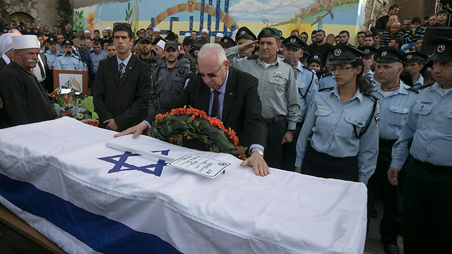 President Reuven Rivlin with Seif's coffin at the funeral (Photo: Reuters)