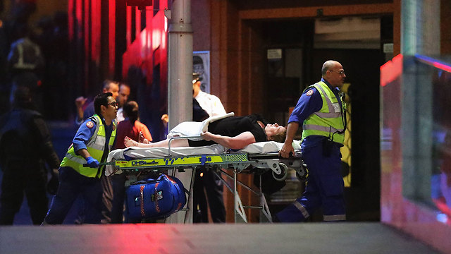 Wounded get medical attention outside of cafe were attack took place. (Photo: Getty Images) (Photo: Getty Images)