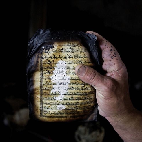 A koran that was burned during the fire in a mosque in the West Bank in November. (Photo: Associated Press) (Photo: Associated Press)