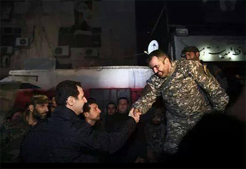 Assad shakes hands with local commander 