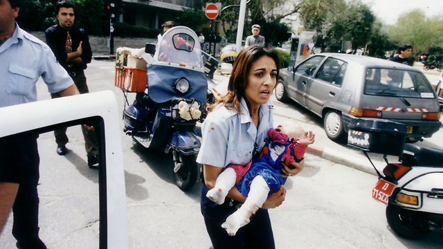 The photo that moved an entire nation - policewoman Ziona Bushri carrying baby Shani after the bombing (Photo: Michael Kremer) (Photo: Michael Kremer)