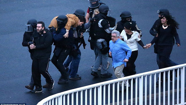 Hostages flee kosher supermarket attack in Paris with help of police.