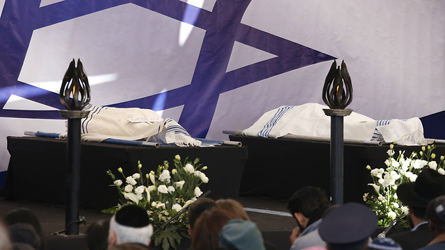 The bodies of the four victims wrapped in prayer shawls ahead of their burial. (Photo: AFP)