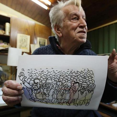 Baha al-Boukhari, who draws for daily al-Ayyam newspaper, shows one of his drawings in Ramallah (Photo: AFP) (Photo: AFP)