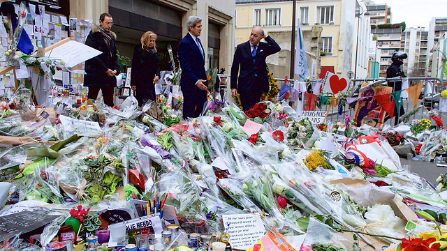 Kerry among wreaths at Charlie Hebdo offices (Photo: EPA)