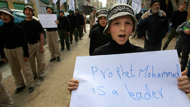 Lebanese child holds up protest sign (Photo: AP)