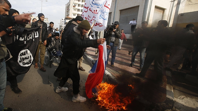 French flag burned and Islamic State flag wave during Gaza rally.(Photo: Reuters)