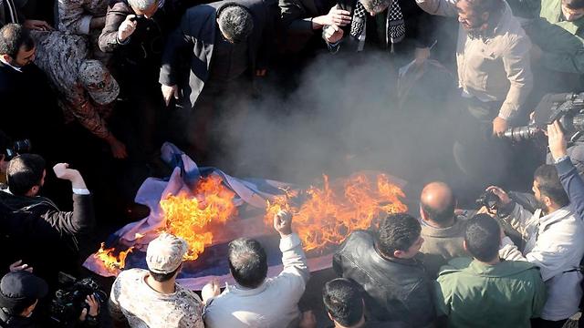 Iranian protesters step on the Israeli flag during the funeral procession (Photo: AFP) (Photo: AFP)