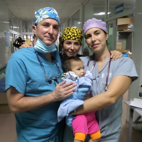 Dr. Omri Emodi (left) with another doctor and a baby Vietnamese patient (Photo: Courtesy of Rambam Health Care Campus) (Photo: Courtesy of Rambam Health Care Campus)