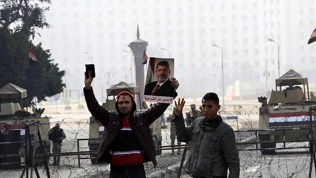 Pro-Morsi protesters outside Tahrir Square, which is sealed off by the military (Photo: EPA)