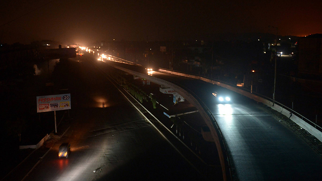 Road lit by car headlights (Photo: AFP)