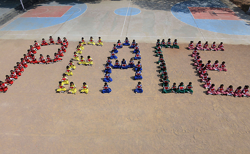 תלמידות בית ספר תיכון לבנות בעיר סקונדרבאד יוצרות את המילה "שלום" במהלך יום השנה ה-67 לרצח מהטמה גנדי. המנהיג ההודי היה בדרכו לתפילה בניו דלהי כשנורה שלוש פעמים בחזהו ובראשו (צילום: AFP) (צילום: AFP)
