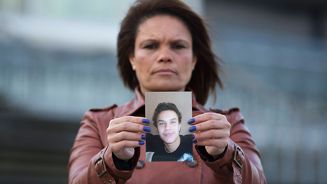 Belgian mother with a picture of her teenage son who left to fight in Syria. (Photo: Reuters)