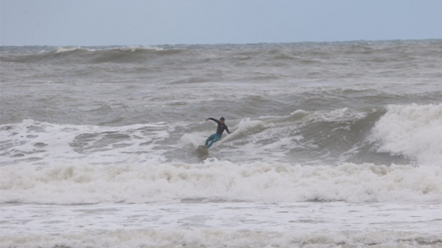 Surfer during last week's stormy weather (Photo: Motti Kimchi)