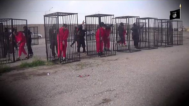 Kurdish fighters caged by the Islamic State.