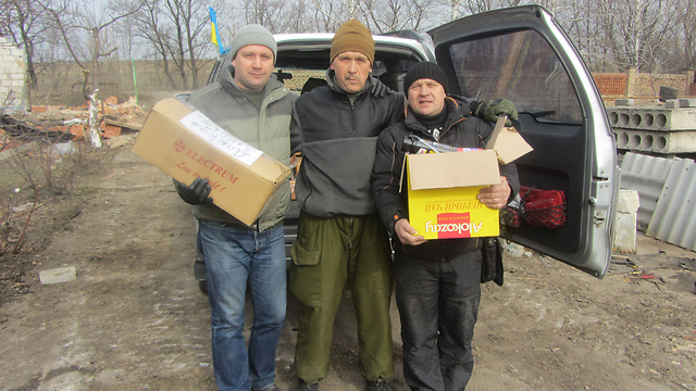 ארגזים לחיילים. המ"כ מיכאליץ' (במרכז) עם שני מתנדבים אוקראינים בפרבומייסקויה (צילום: אדוארד דוקס) (צילום: אדוארד דוקס)