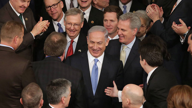 Netanyahu greeted by Congress members. One of their own (Photo: AFP)   