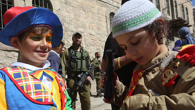 Purim festivities in Hebron. (Photo: Gil Yohanan) 