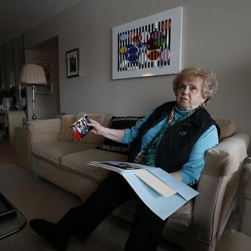 Holocaust survivor and author Paula Burger, sits in living room reminiscing over photos of her children and grandchildren (Photo: AP) (Photo: AP)