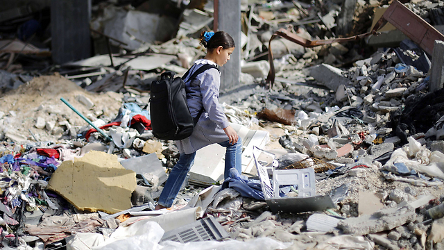 Girl walking through rubble in Gaza in March (Photo: AFP)