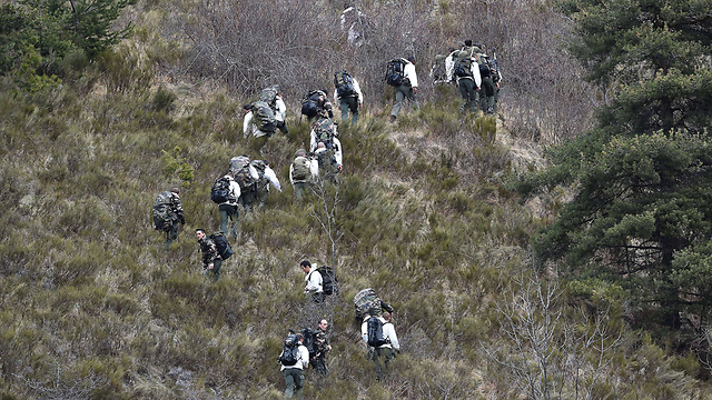 French military personnel on mountainside near site of crash (Photo: AFP) (Photo: AFP)