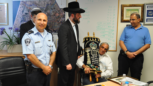 With the Torah scroll (Photo: Israel Police)