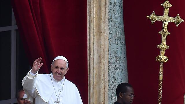 Pope Francis greets the crowd from the central loggia of St Peters' basilica (Photo: AFP)