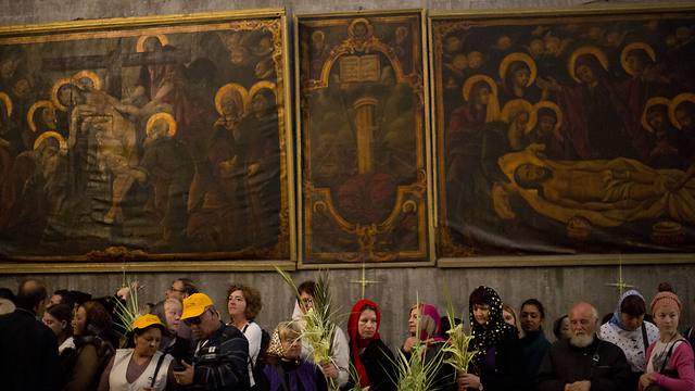 Greek Orthodox worshipers hold a palm fond in the Church of the Holy Sepulcher during Orthodox Palm Sunday in Jerusalem (Photo: AP)