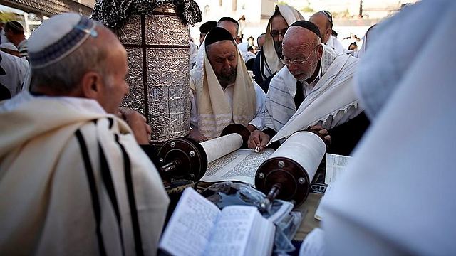 Reading from the Torah (Photo: AFP)