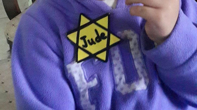 The yellow Star of David attached to the toddlers' clothes.