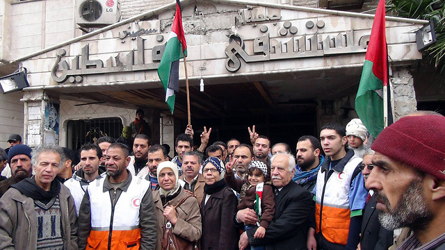 Palestinians protest in front of a hospital in Yarmouk (Photo: AFP)