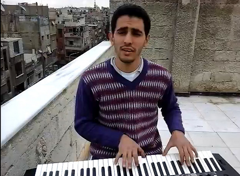 Ayyam al-Ahmad playing on a rooftop 