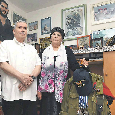 Ori Azulai's parents in his room, with his uniform (Photo: Efi Shrir) 