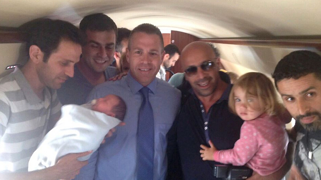 Interior Minister Gilad Erdan with Israelis who returned rom Nepal with surrogate babies. 