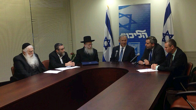 Netanyahu signing coalition deal with United Torah Judaism leaders.